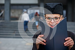 Pretty, young woman celebrating joyfully her graduation