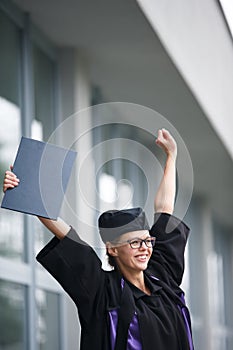 Pretty, young woman celebrating joyfully her graduation