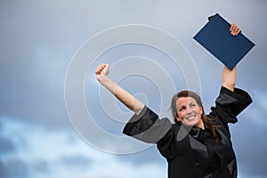 Pretty, young woman celebrating joyfully her graduation