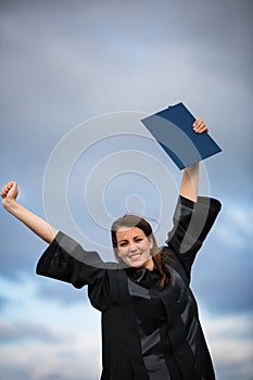 Pretty, young woman celebrating joyfully her graduation