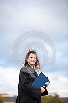 Pretty, young woman celebrating joyfully her graduation