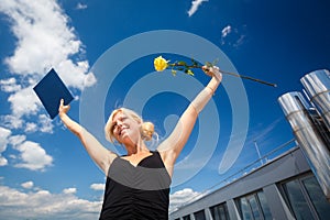 Pretty, young woman celebrating joyfully her graduation