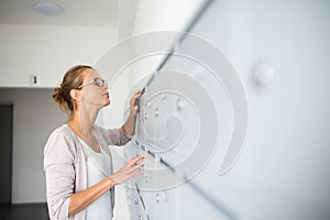 Pretty, young woman checking her mailbox