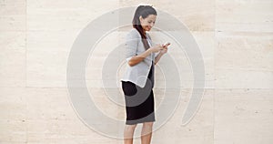 Pretty young woman checking her mobile phone