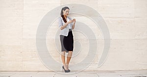 Pretty young woman checking her mobile phone