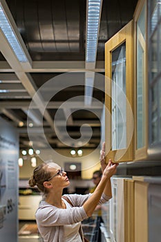 Pretty, young woman choosing the right furniture