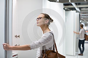 Pretty, young woman choosing the right furniture