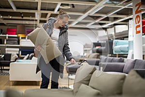 Pretty, young woman choosing the right furniture