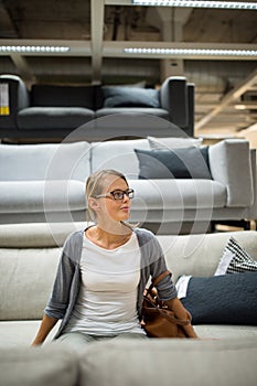 Pretty, young woman choosing the right furniture