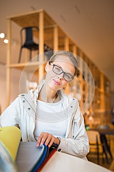 Pretty young woman choosing the right material/color