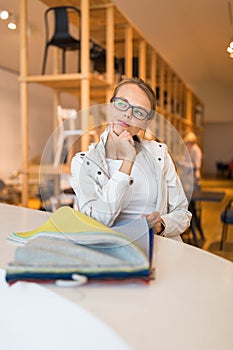 Pretty young woman  choosing the right material/color for her modern appartement interior