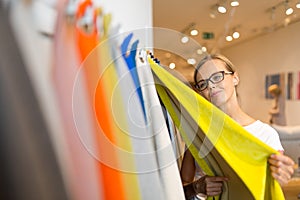 Pretty young woman  choosing the right material/color for her modern appartement interior