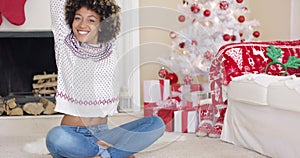 Pretty young woman in Christmas living room