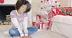 Pretty young woman in Christmas living room