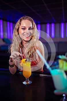 Pretty young woman with cocktail nightclub