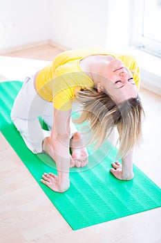 Pretty young woman doing YOGA exercise