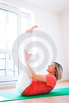 Pretty young woman doing YOGA exercise