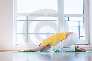 Pretty young woman doing YOGA exercise