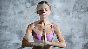 Pretty young woman doing yoga exercise at home.