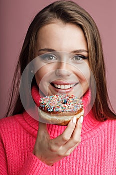 pretty young woman with donut in studio