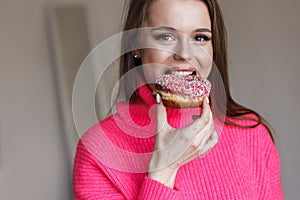 pretty young woman with donut in studio