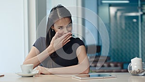 Pretty young woman drinking tea and flirting in a coffee house