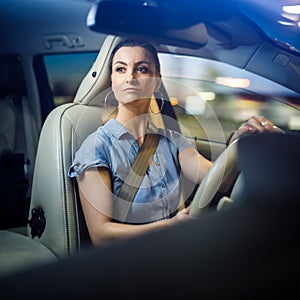 Pretty, young woman driving a car