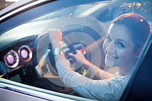 Pretty young woman driving her brand new car