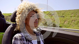 Pretty young woman driving her cabriolet car