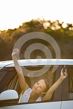 Pretty, young woman driving her car