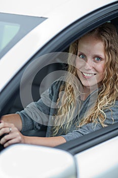 Pretty young woman driving her car