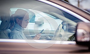 Pretty, young woman driving her new car