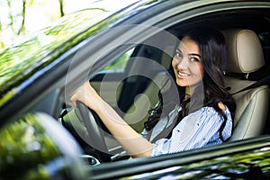 Pretty young woman driving her new car. Womanm drive car in the city