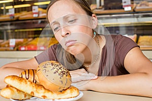 Pretty young woman eating sweets in the cafe. Bad habits. Health