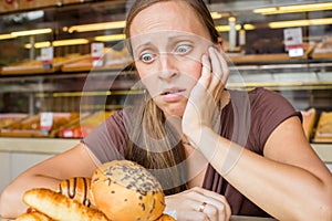 Pretty young woman eating sweets in the cafe. Bad habits. Health