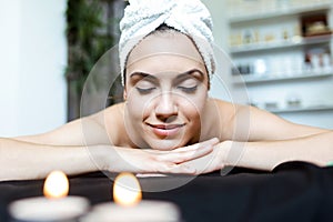 Pretty young woman enjoying massage at beauty spa.