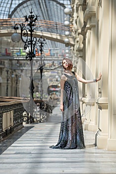 Pretty young woman in a fashionable flutter transparent cape