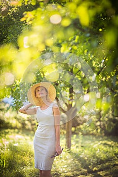 Pretty, young woman gardening in her garden