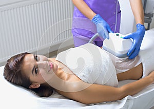 Pretty young woman getting cryolipolyse treatment