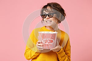 Pretty young woman girl in 3d imax glasses posing isolated on pink background. People sincere emotions in cinema