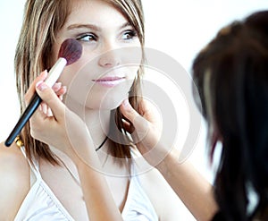 Pretty young woman having powder