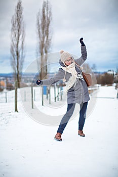Pretty, young woman having troubles walking on an icy photo