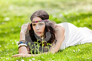 Pretty young woman in a headband daydreaming