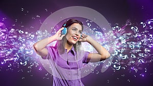 Pretty young woman with headphones listening to music