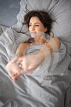 Pretty, young woman in her bed, fast asleep.