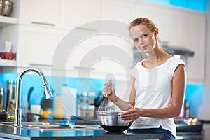 Pretty, young woman in her modern kitchen