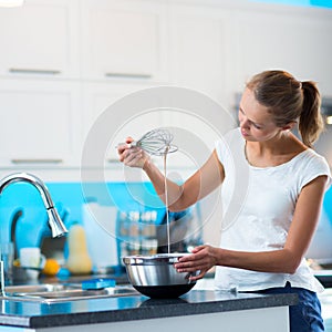Pretty, young woman in her modern kitchen