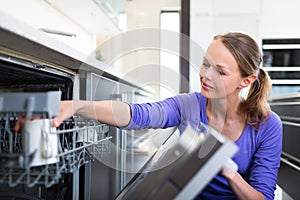 Pretty, young woman in her modern and well equiped kitchen