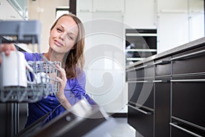 Pretty, young woman in her modern and well equiped kitchen