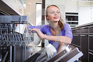 Pretty, young woman in her modern and well equiped kitchen